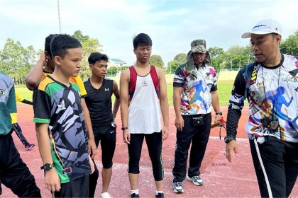 3. A teacher getting the students ready for their track event   